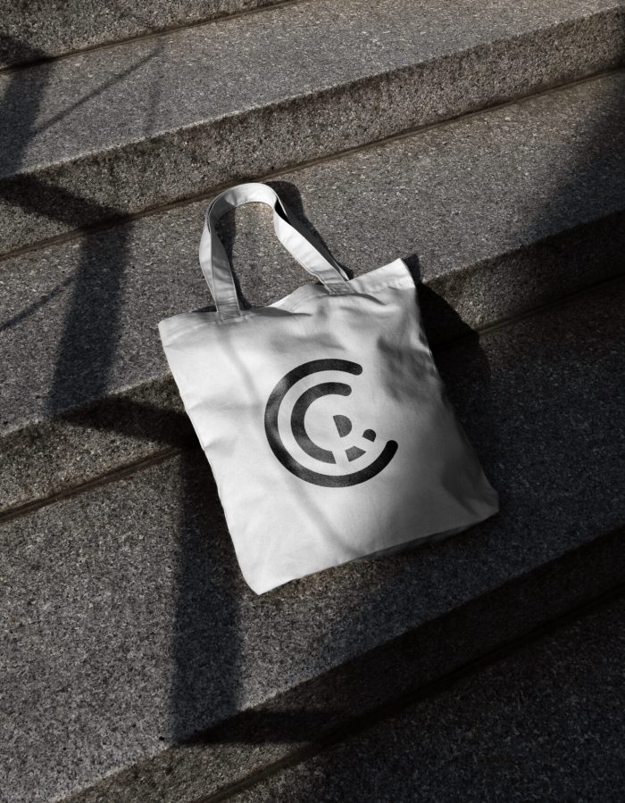 Tote bag mockup template on a concrete ladder with deep sunlit s